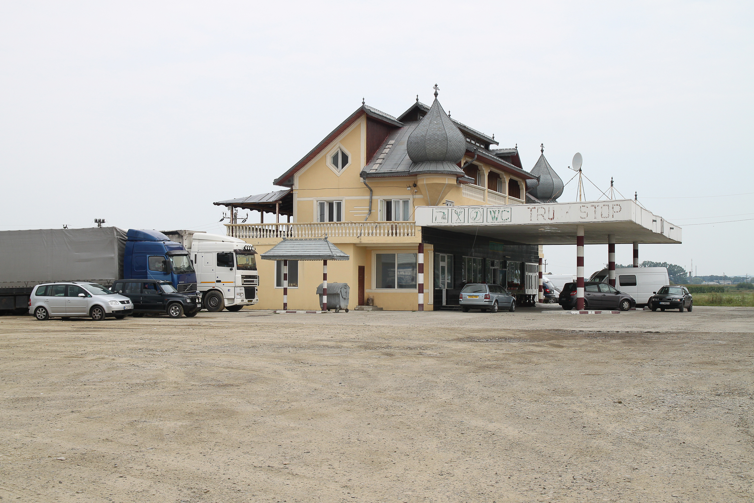 Corridor 9. E85 in Romania: a disused gas station kiosk from communist times transformed into a generic rustic inn by a Roma family.