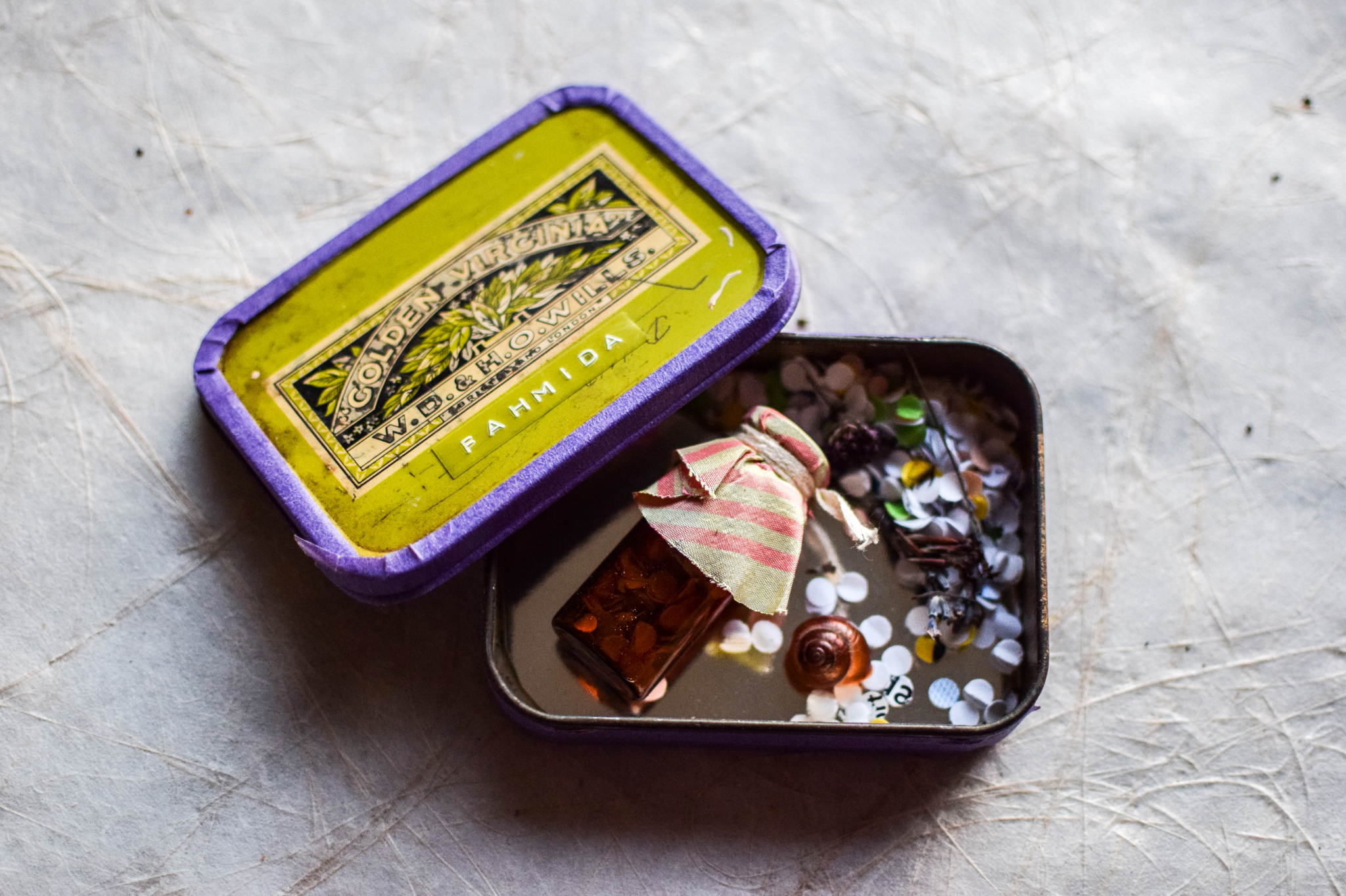 Image 8: Fahmida’s miniature archive, her ›pocket of togetherness‹ including a snail shell and some small colourful paper shreds, symbolising the different stories and knowledges shared by the women over the weekend. ©Rebekka Hölzle